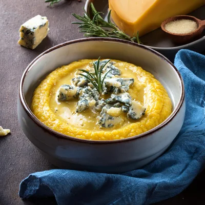 Creamy Polenta Topped With Gorgonzola Cheese And Rosemary