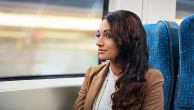 Young Woman Looking Out Train Window During Commute
