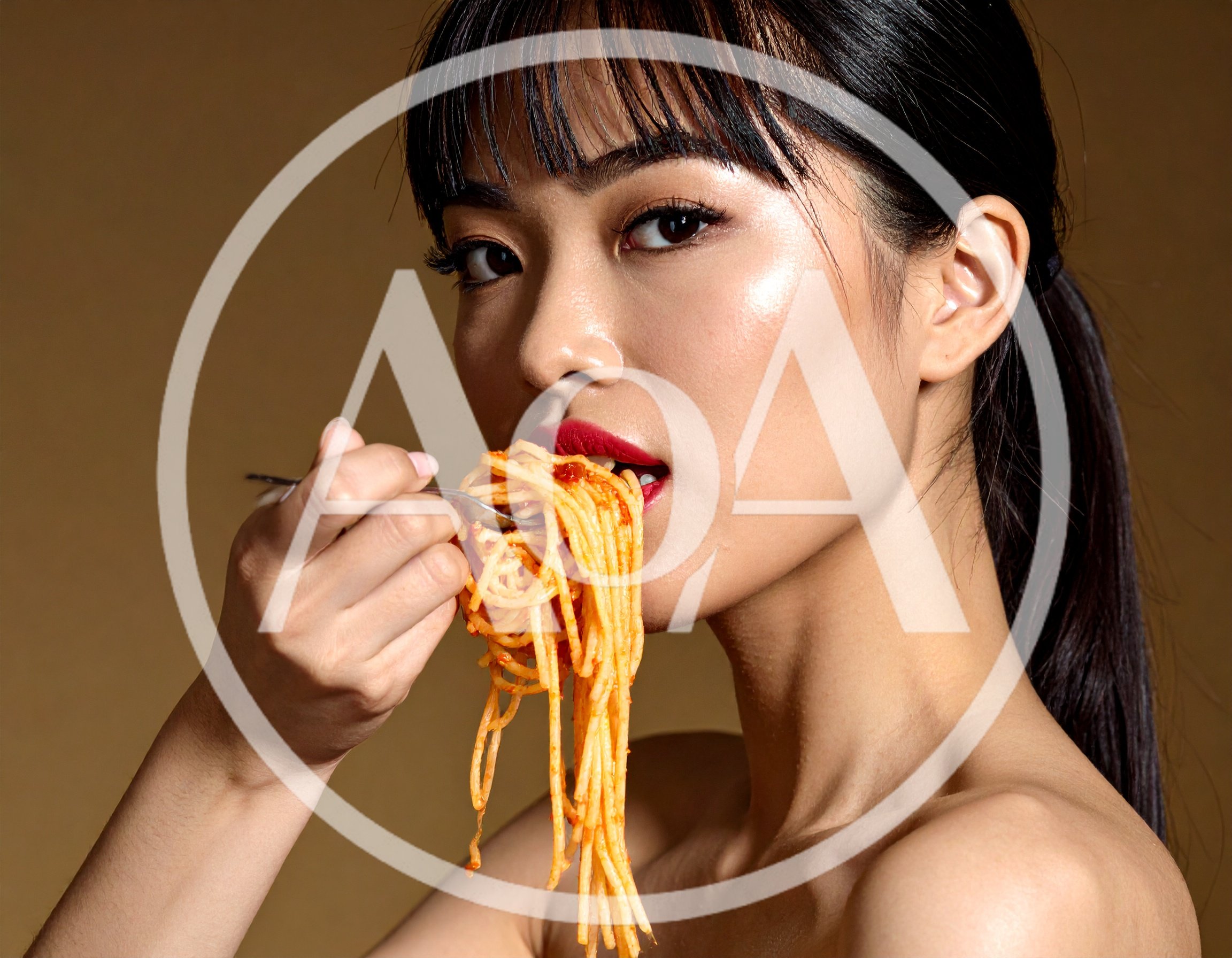 Young Asian Woman Eating Spaghetti With A Fork