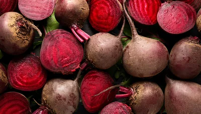 Fresh Raw Beetroots With Green Leaves On Dark Background