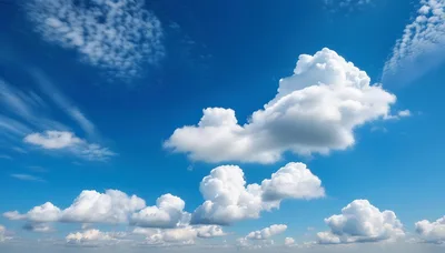 Fluffy White Cumulus Clouds In A Bright Blue Sky