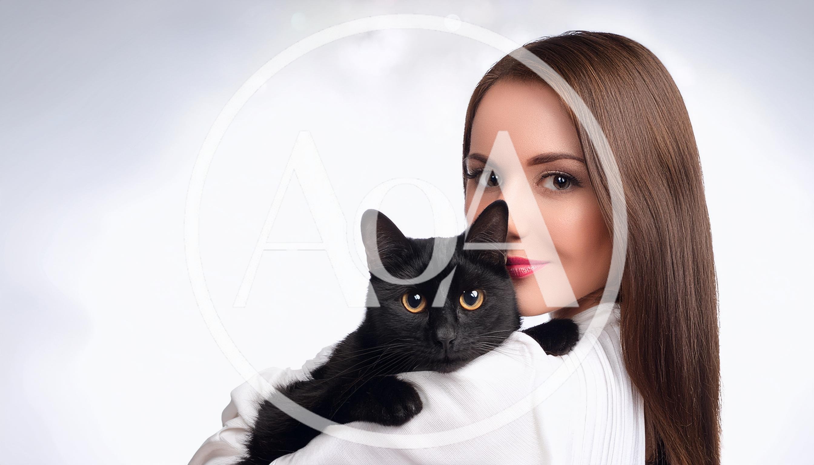 Young Woman Holding A Black Cat