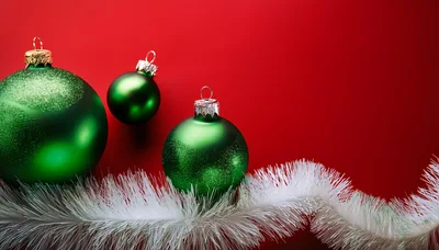 Green Christmas Ornaments With White Tinsel On Red Background