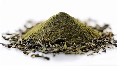 Pile Of Green Tea Powder With Dried Tea Leaves