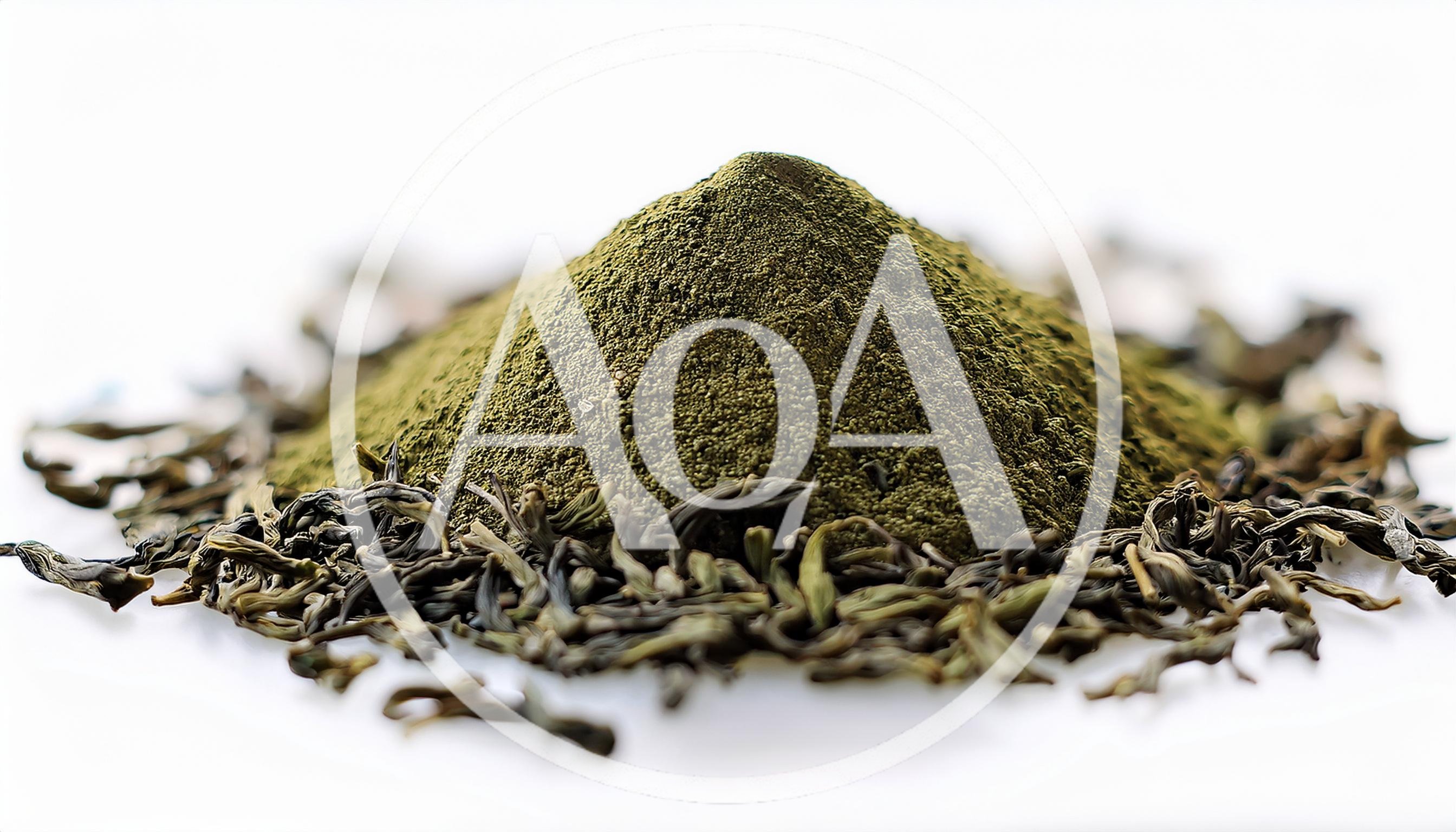 Pile Of Green Tea Powder With Dried Tea Leaves