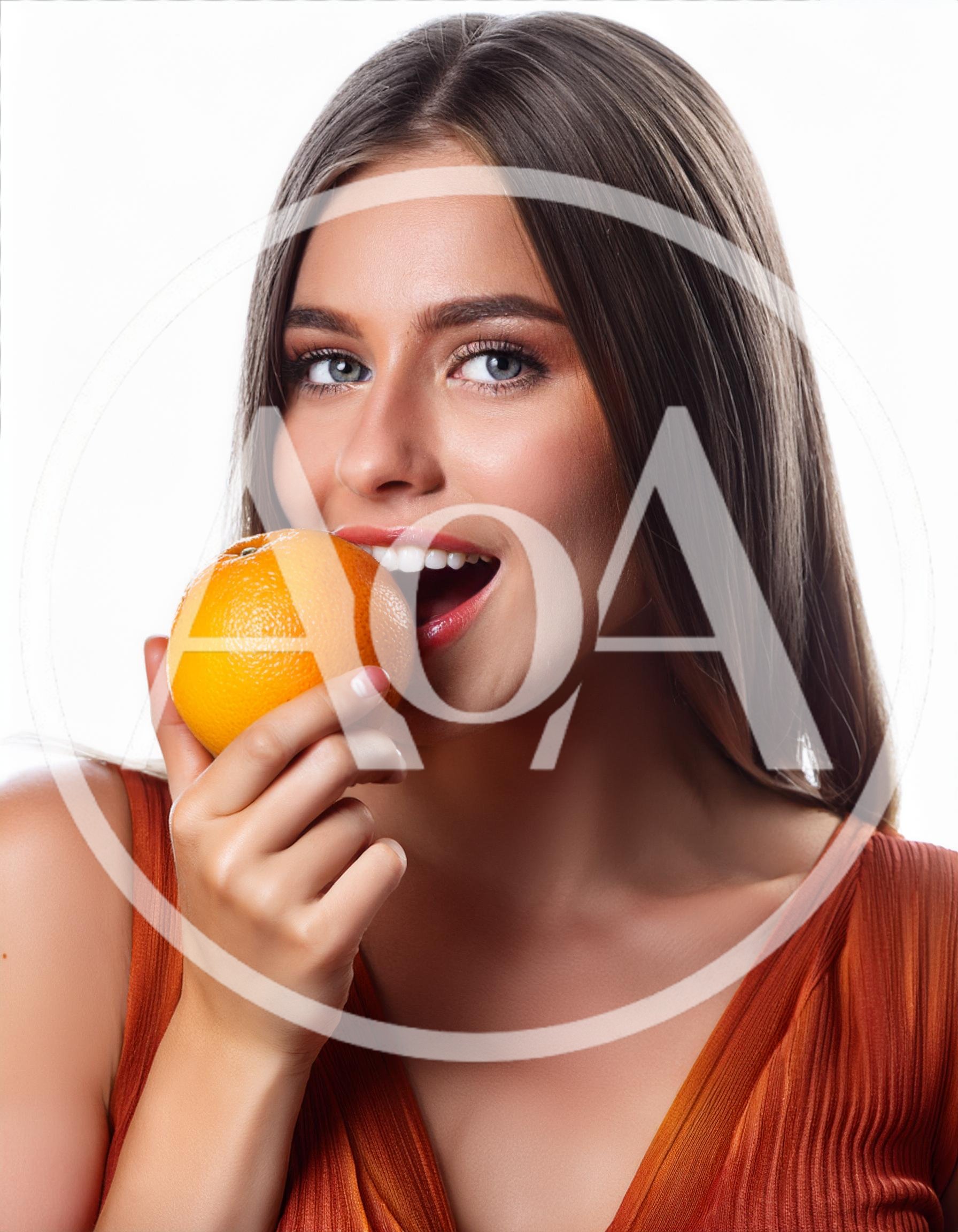 Beautiful Young Woman Holding A Fresh Orange