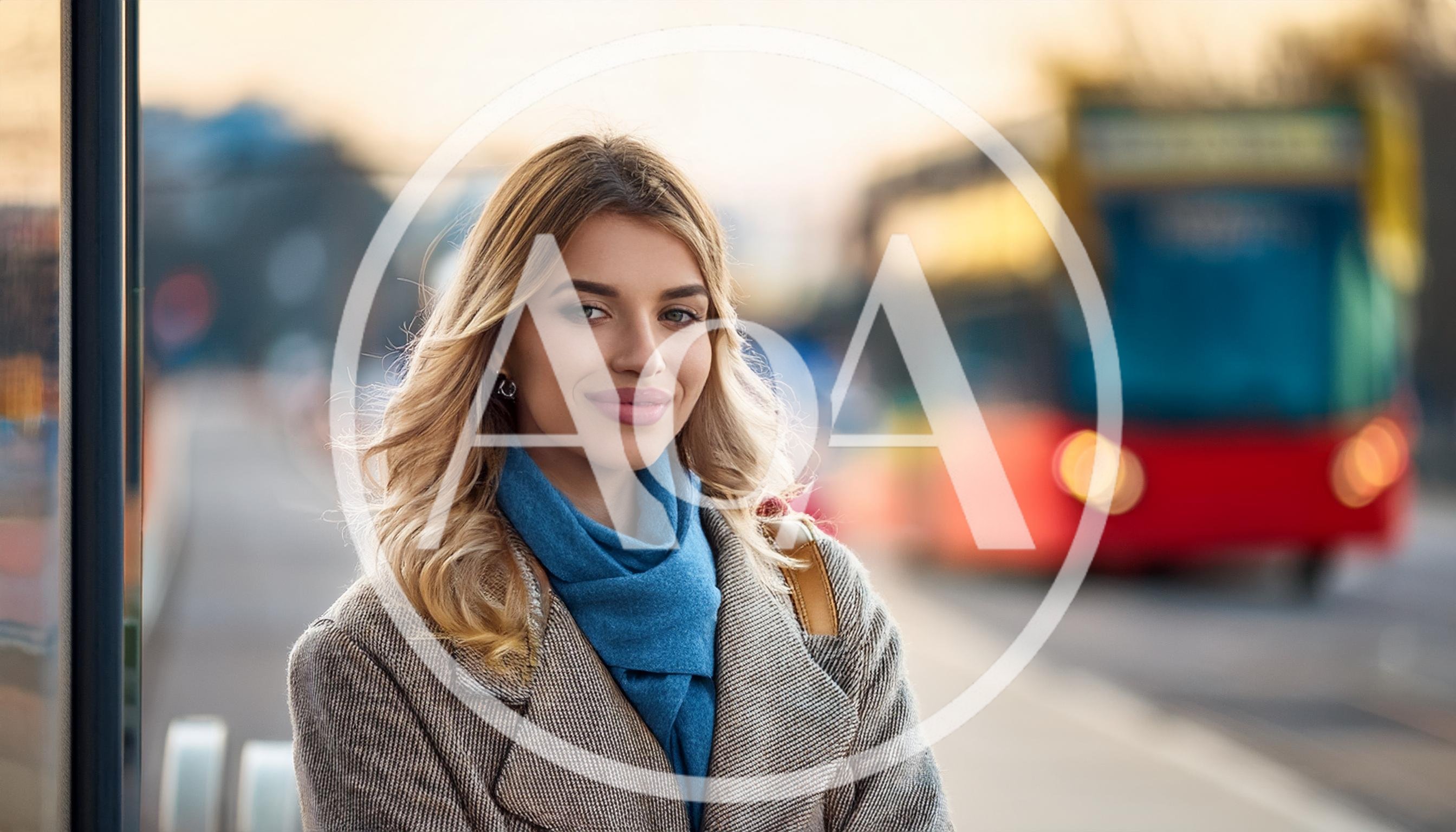 Young Woman Waiting At A City Bus Stop