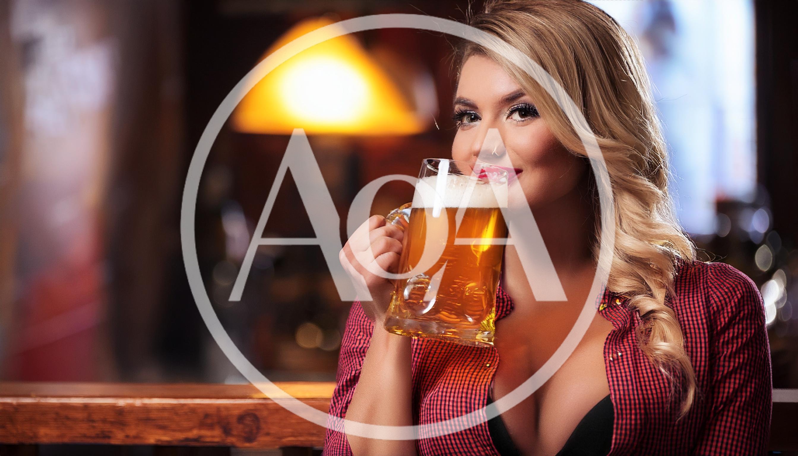 Attractive Blonde Woman Drinking Beer In A Pub