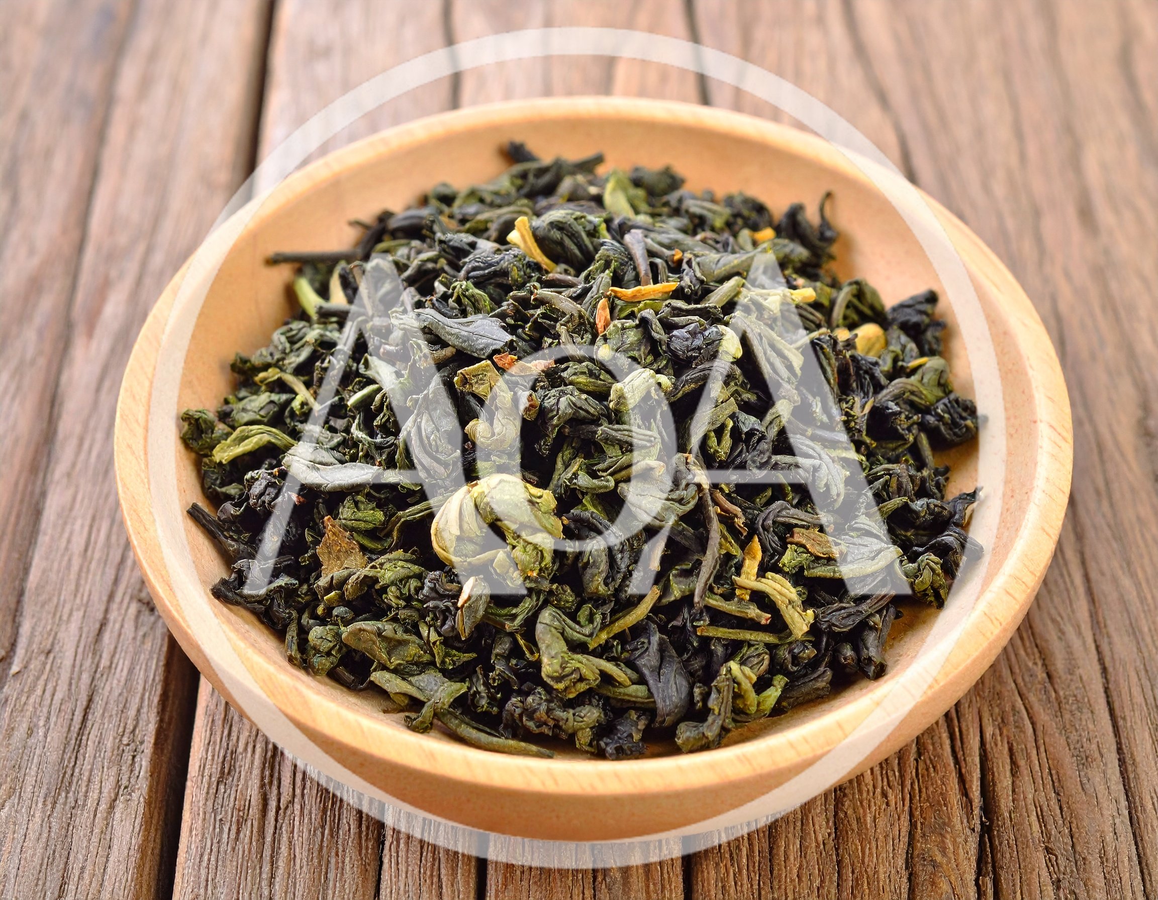 Dried Green Tea Leaves In A Wooden Bowl