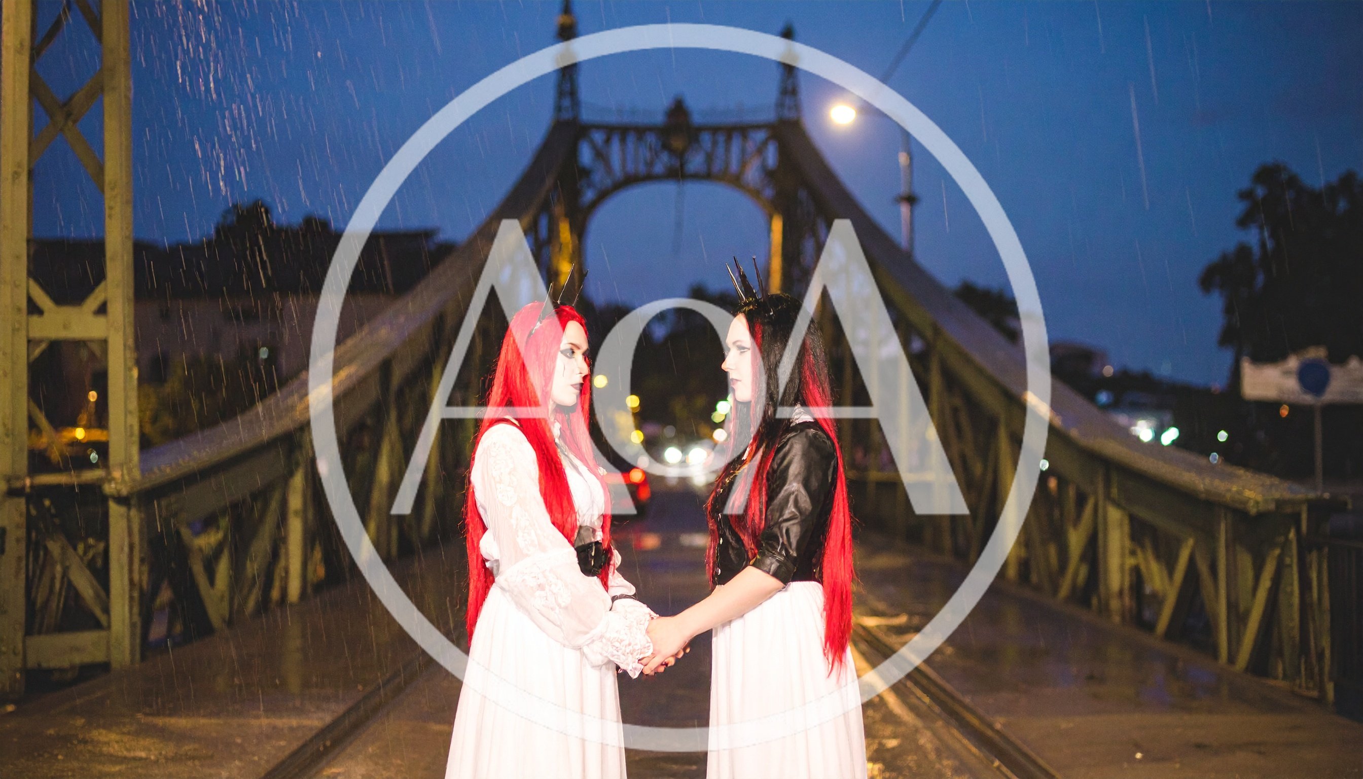 Two Gothic Women Holding Hands on a Rainy Bridge