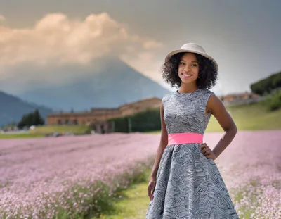 Young Woman Standing In A Blooming Lavender Field