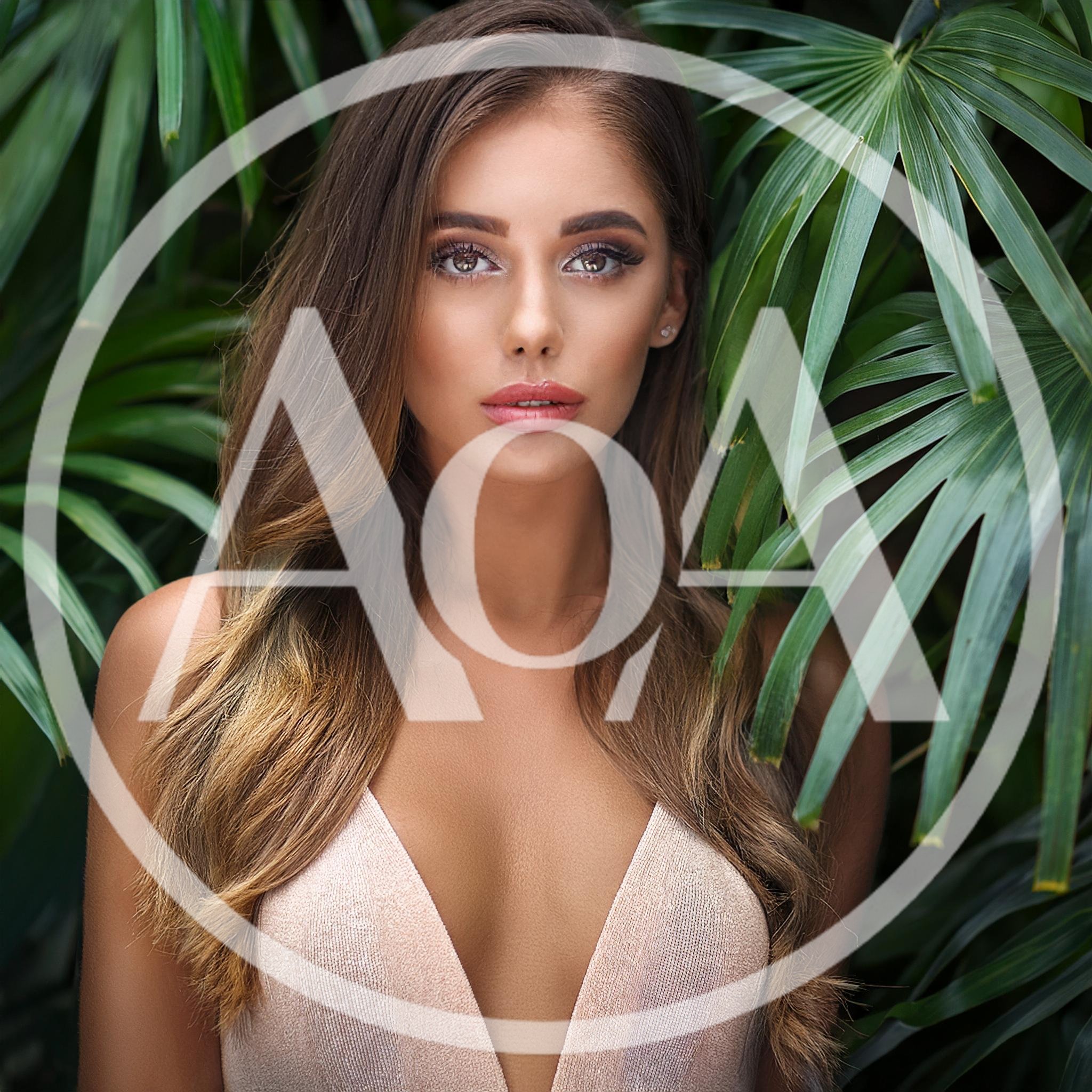 Portrait Of A Beautiful Woman In Tropical Foliage