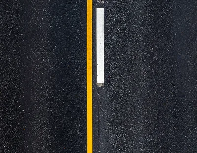 Top Down View Of Wet Asphalt Road Markings