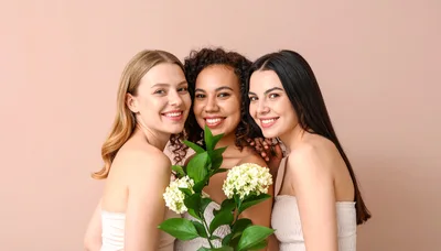 Three Diverse Women Smiling Together With Hydrangea Flowers