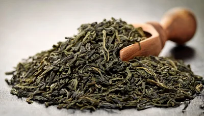 Dried Green Tea Leaves With Wooden Scoop