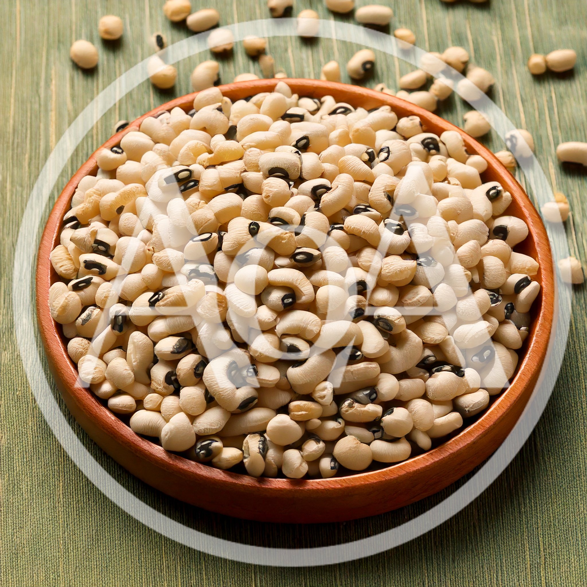 Bowl Of Raw Black Eyed Peas On Green Surface