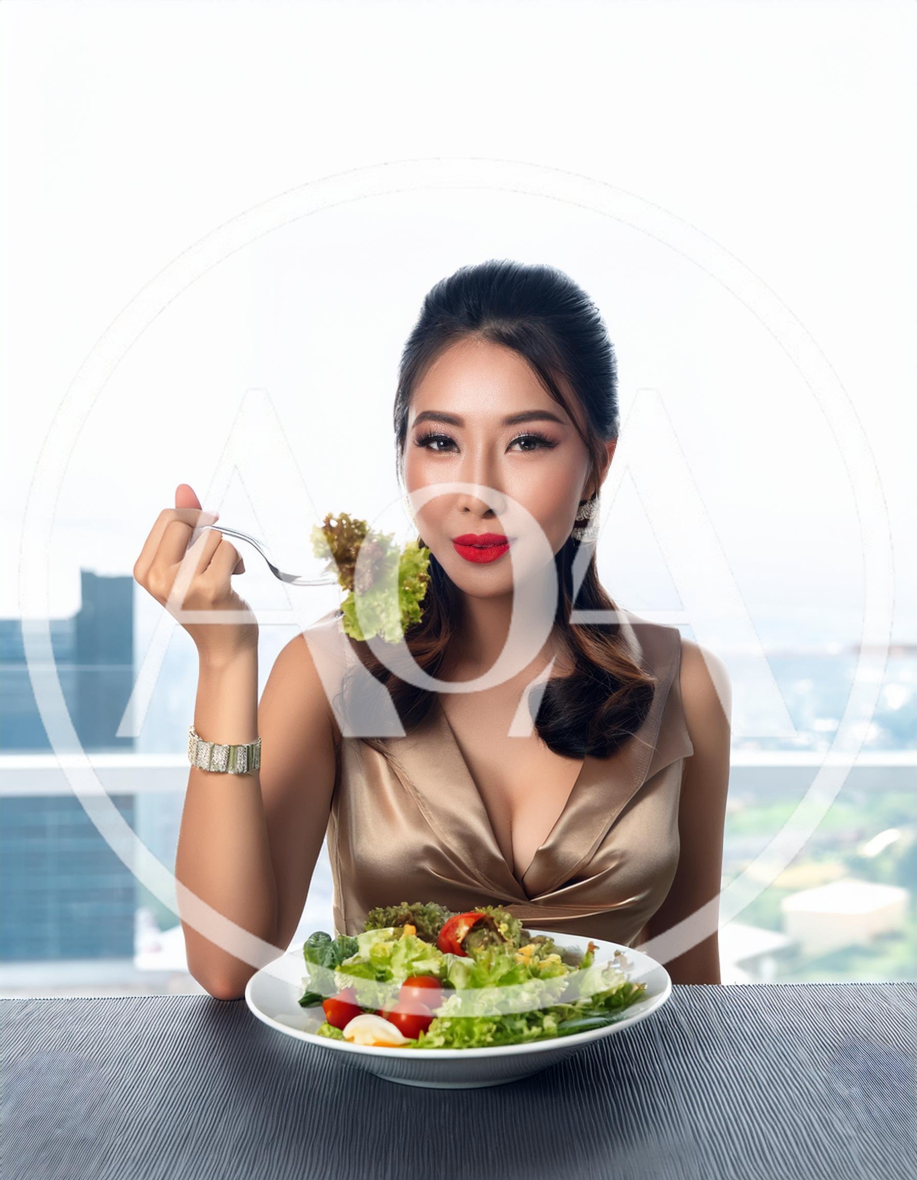 Elegant Woman Eating Fresh Salad in High Rise Restaurant