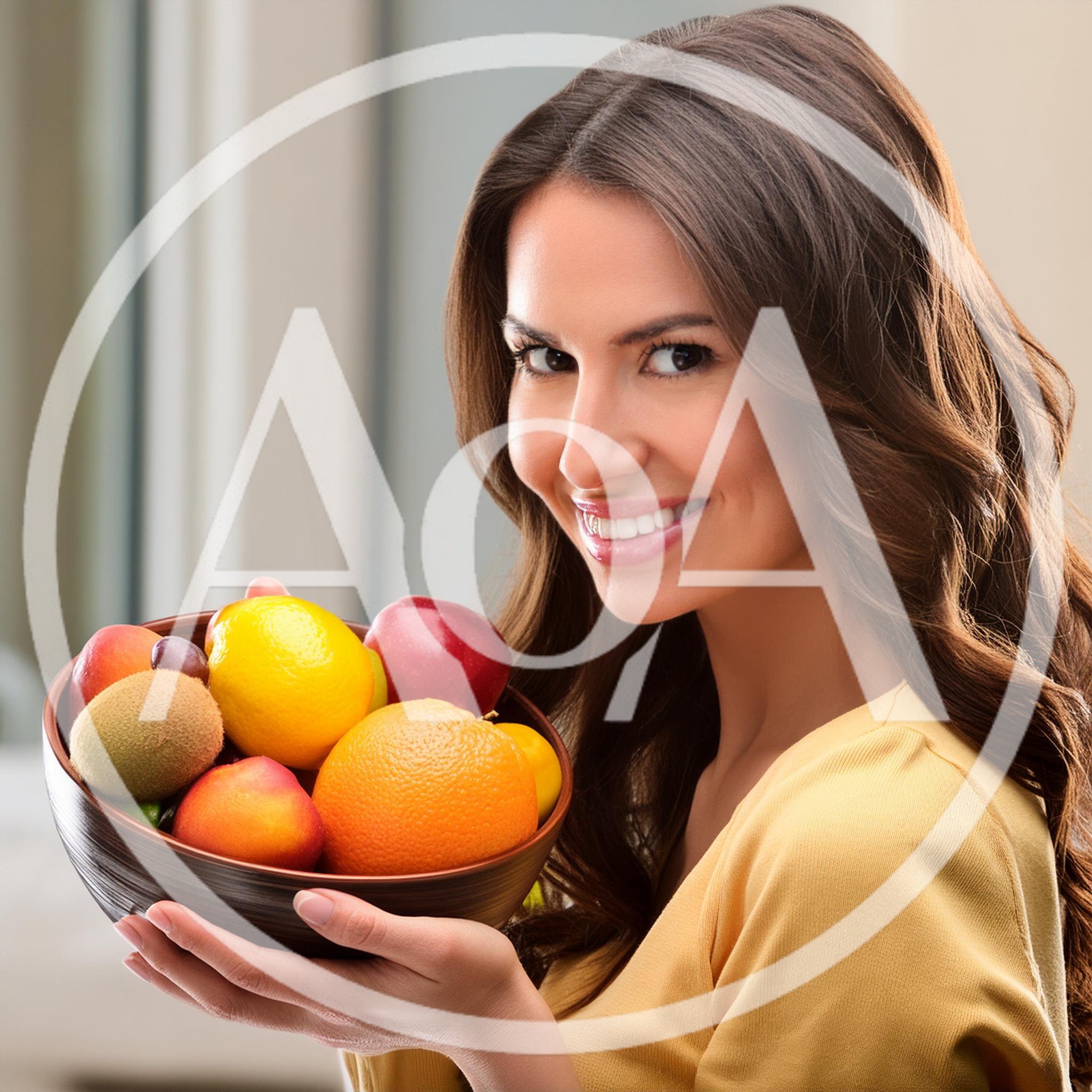 Smiling Woman Holding A Bowl Of Fresh Fruit