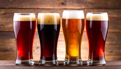 Four Glasses Of Different Craft Beers On Wooden Background