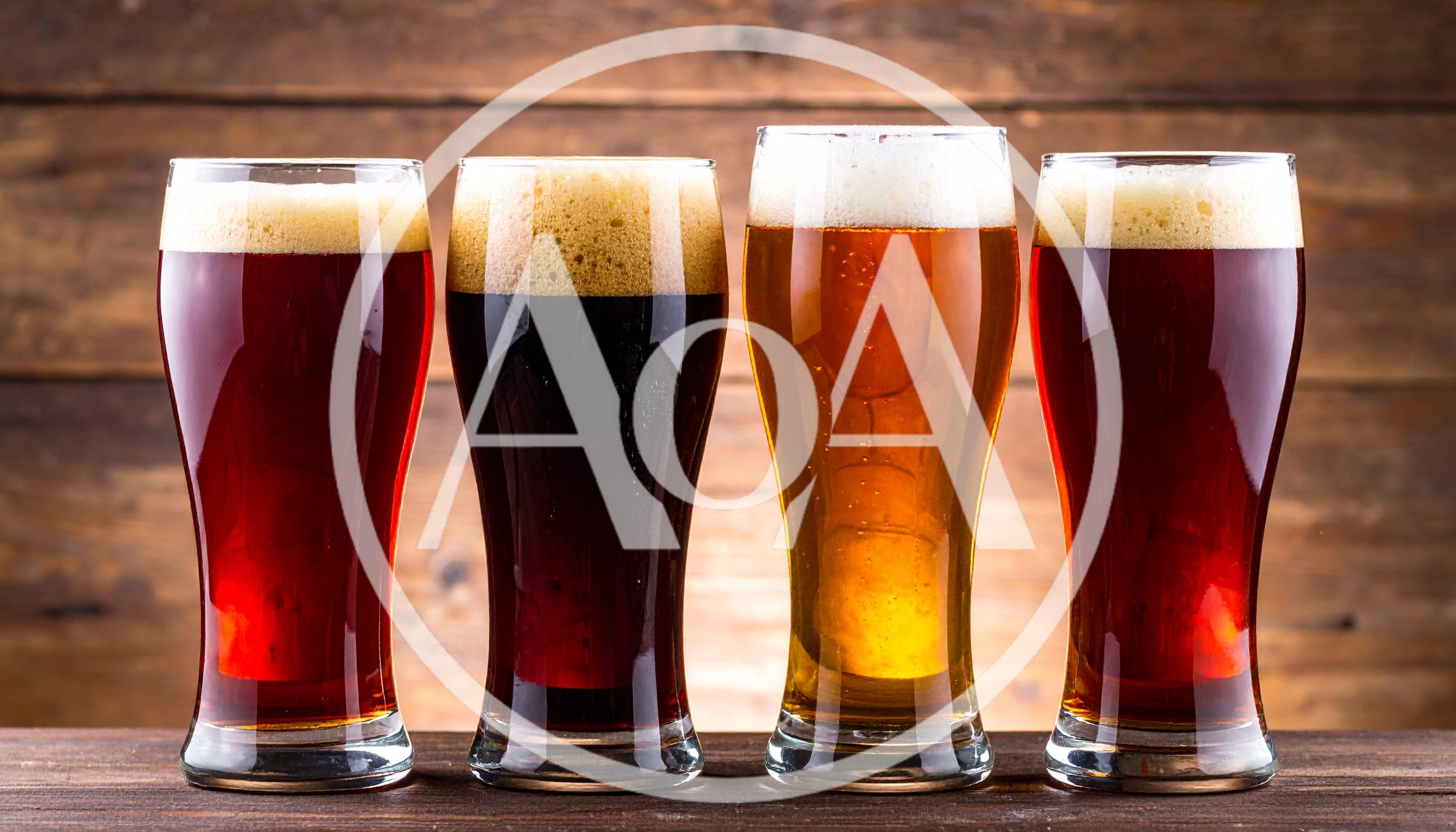 Four Glasses Of Different Craft Beers On Wooden Background