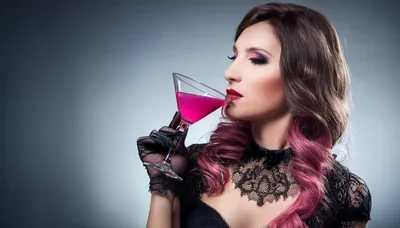 Elegant Woman Drinking Pink Cocktail in Lace Gloves
