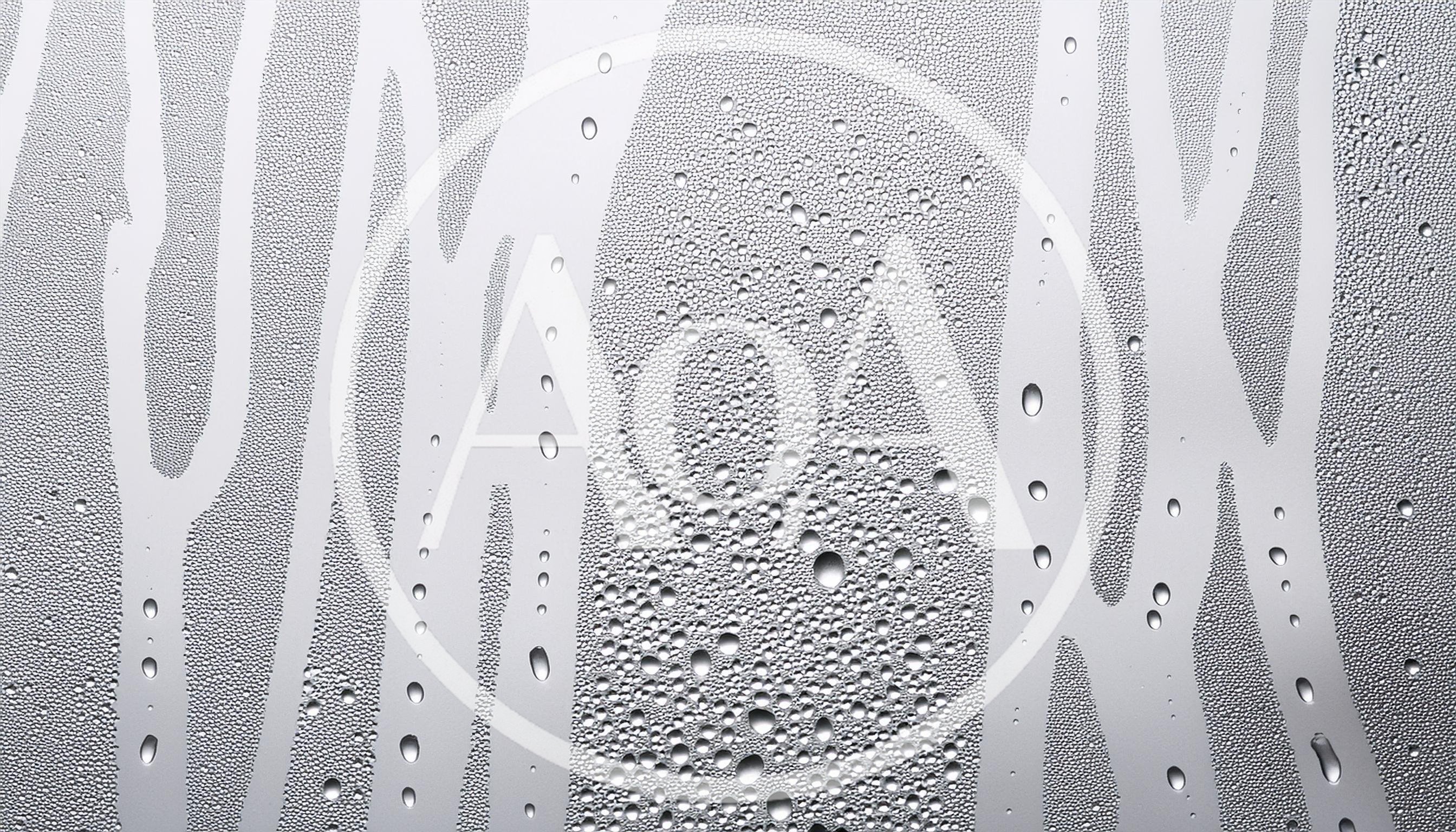Water Droplets Running Down A Glass Surface