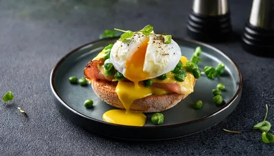 Poached Egg Benedict With Peas And Ham On Toast