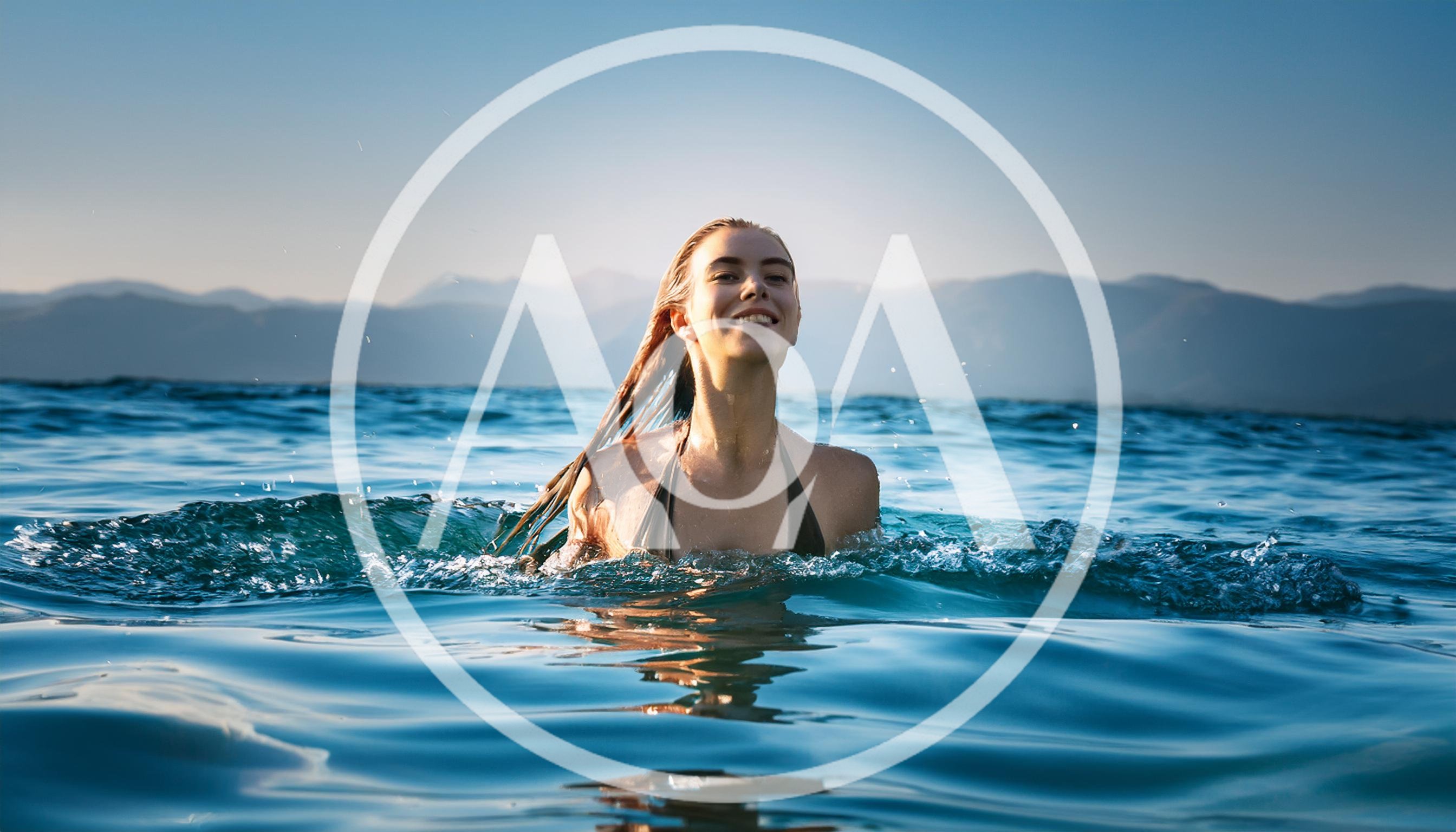 Young Woman Swimming In A Calm Mountain Lake
