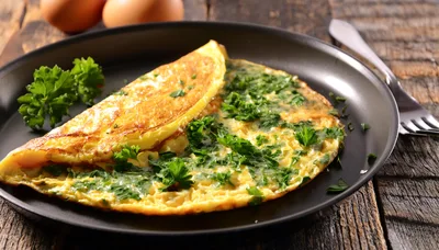 Fresh Herb Omelet Served On A Black Plate