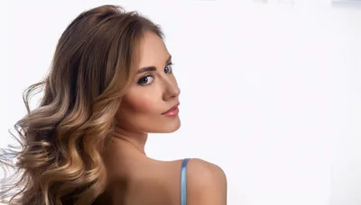 Beautiful Woman With Wavy Hair Looking Over Shoulder