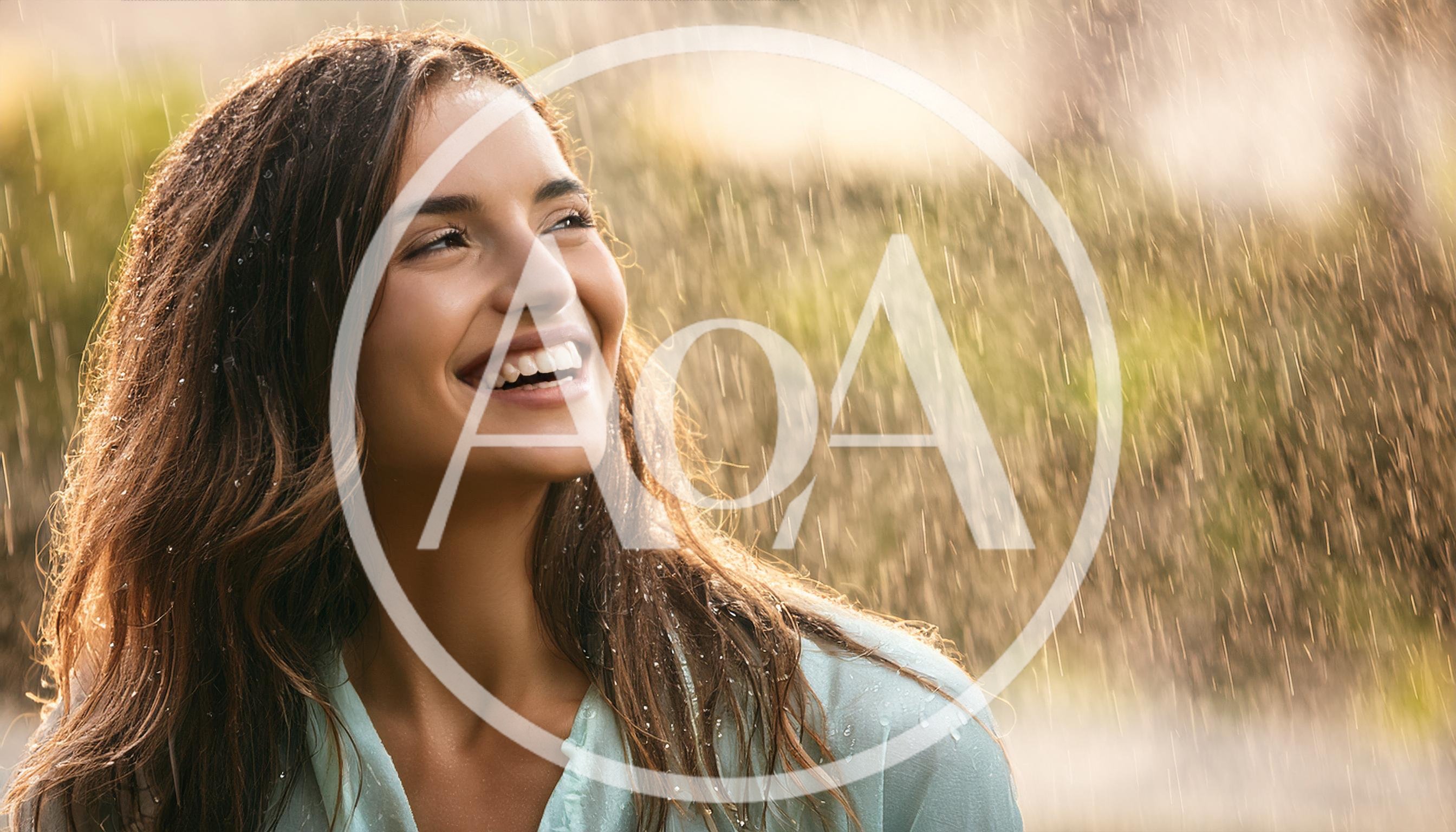 Happy Woman Enjoying Warm Summer Rain Outdoors