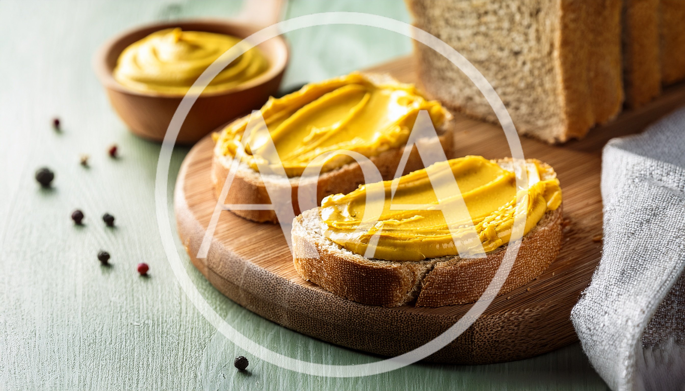 Mustard Spread On Slices Of Whole Grain Bread