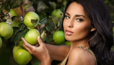 Beautiful Woman Picking Fresh Green Apples In Orchard