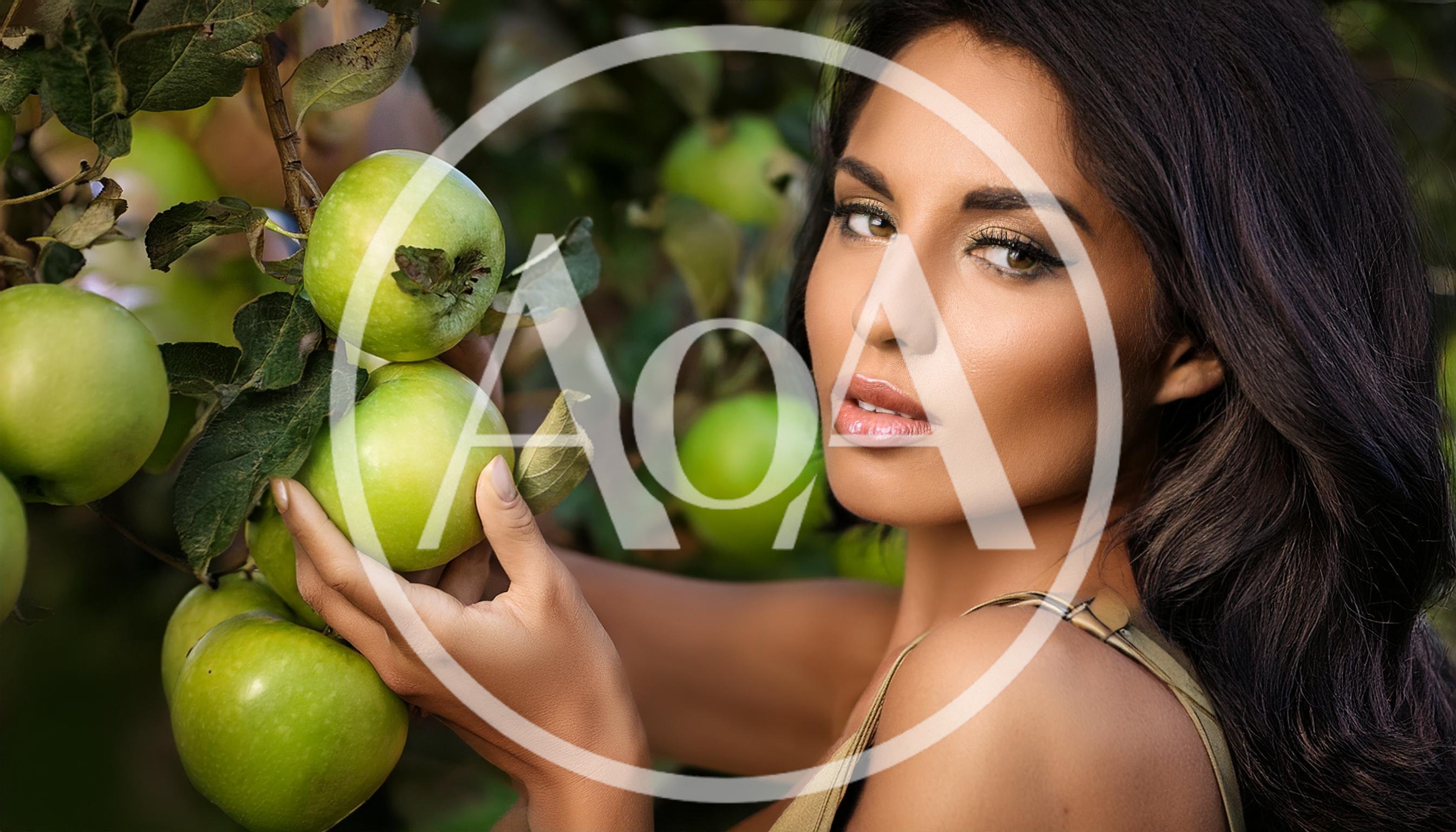 Beautiful Woman Picking Fresh Green Apples In Orchard