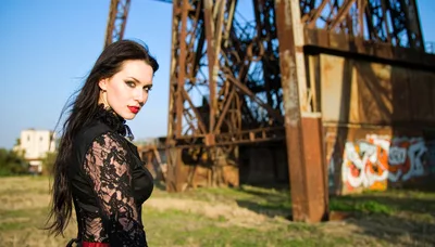 Gothic Woman Posing Near Industrial Metal Structure