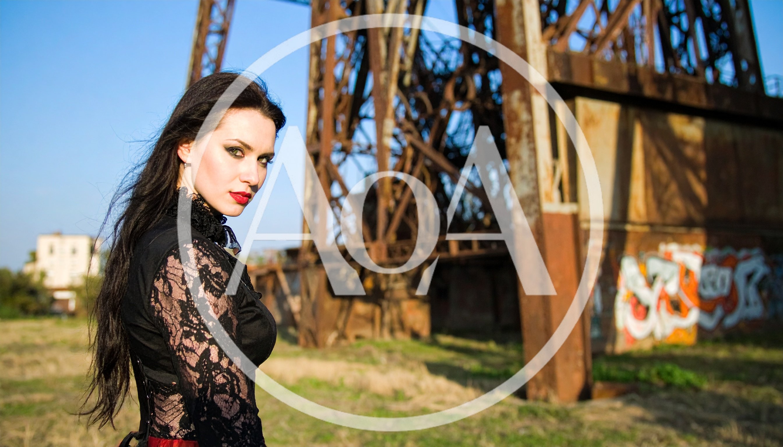 Gothic Woman Posing Near Industrial Metal Structure