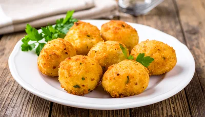 Fried Potato Croquettes Served On A White Plate