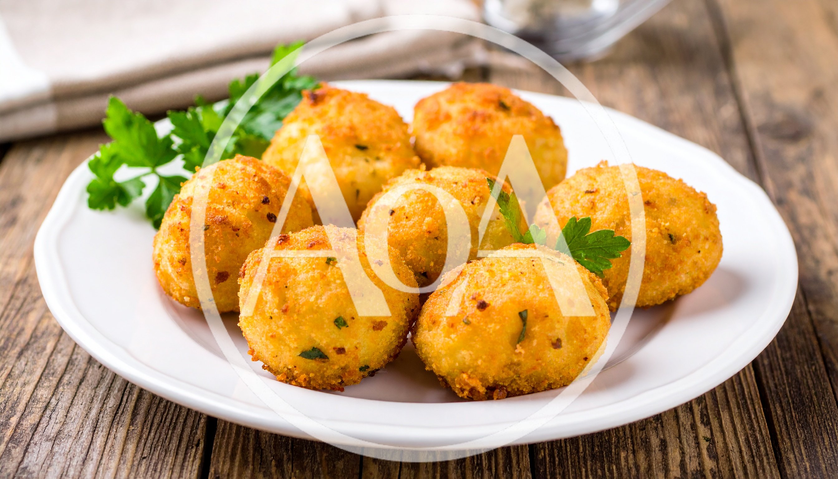 Fried Potato Croquettes Served On A White Plate
