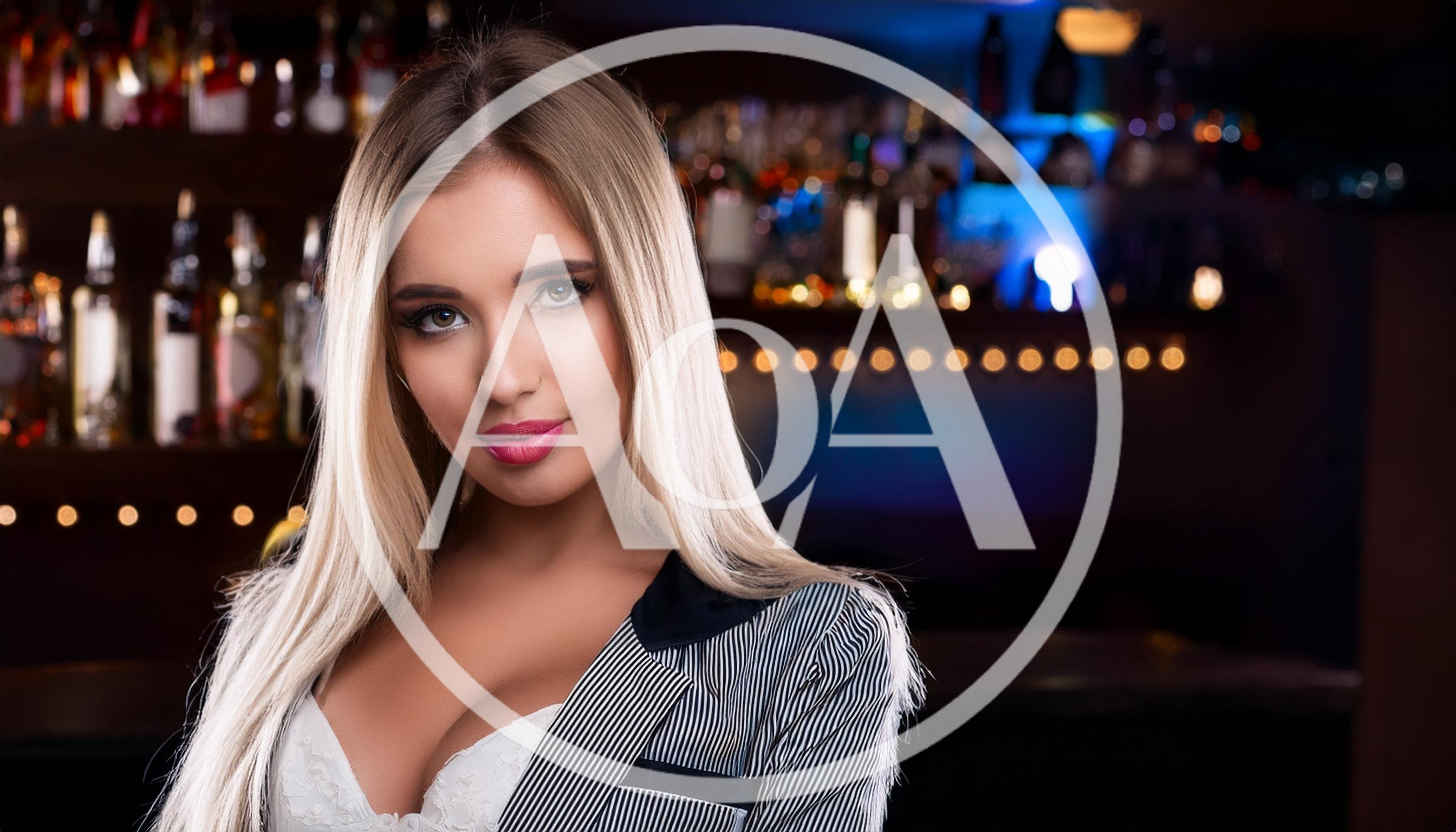 Beautiful Blonde Woman Posing In A Bar