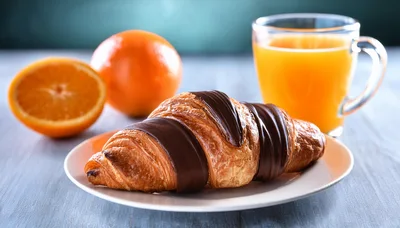 Chocolate Drizzled Croissant With Orange Juice And Oranges