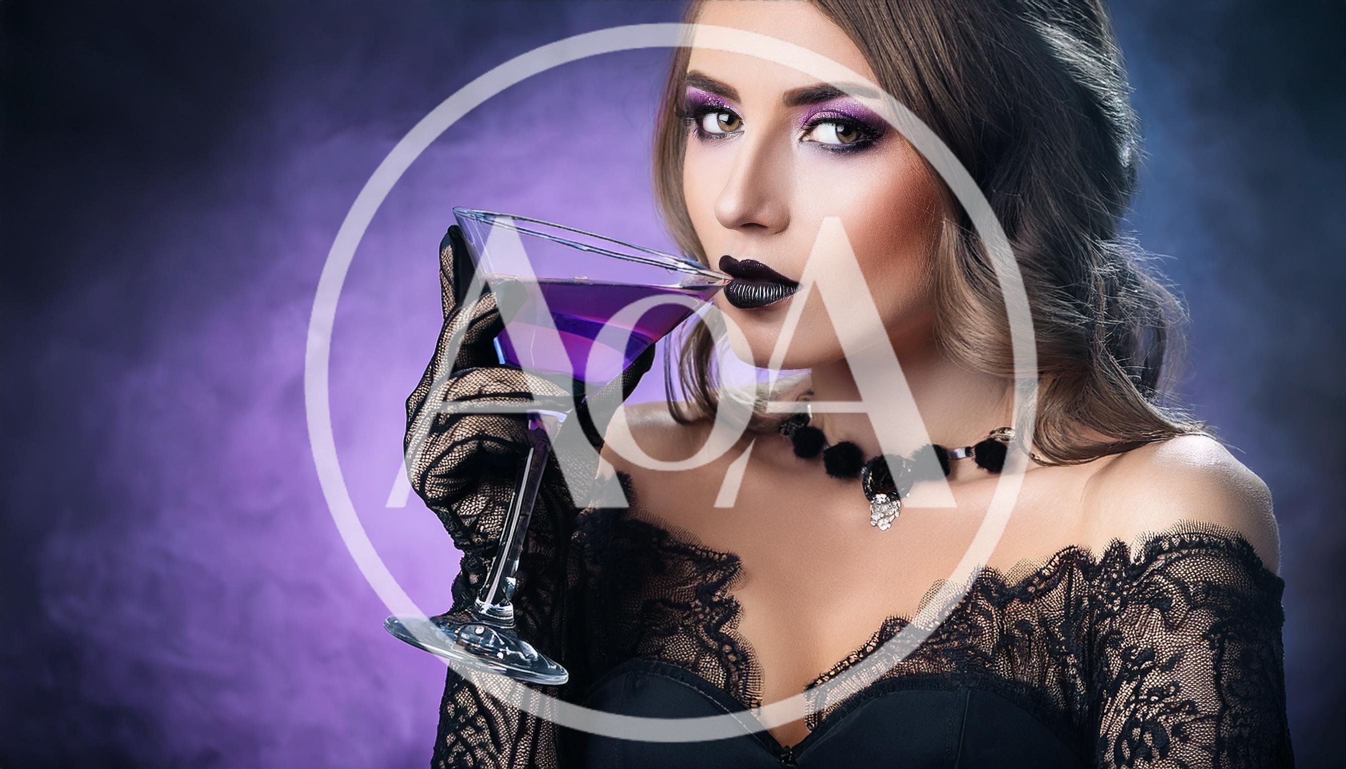 Elegant Woman Holding A Purple Martini Glass