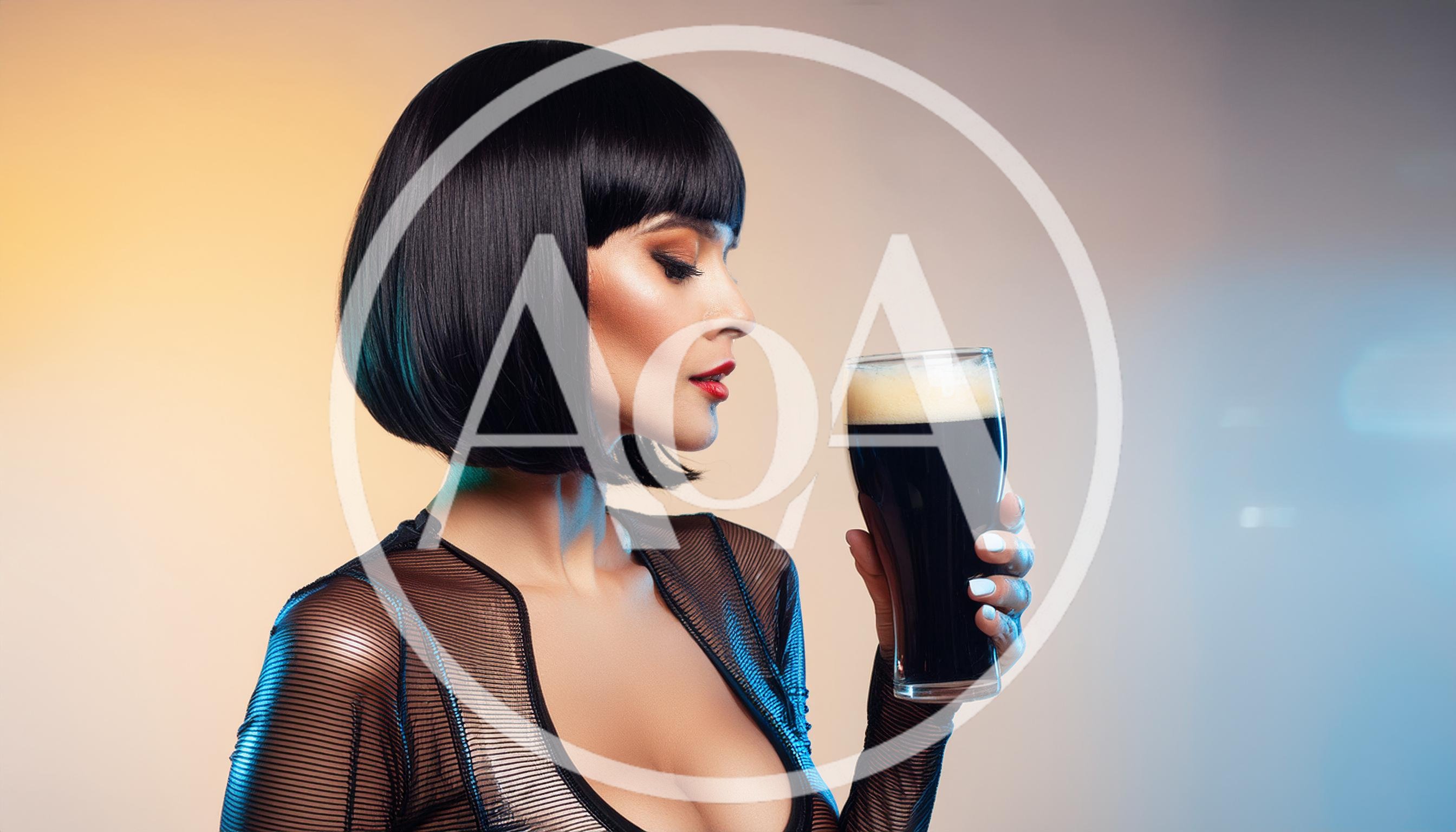 Woman With Bob Haircut Holding A Glass Of Stout