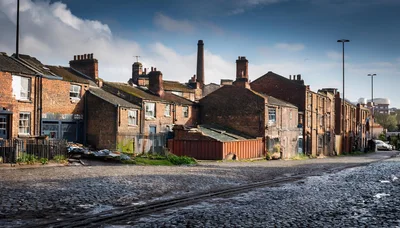 Old Industrial Brick Terraced Houses On Cobblestone Street