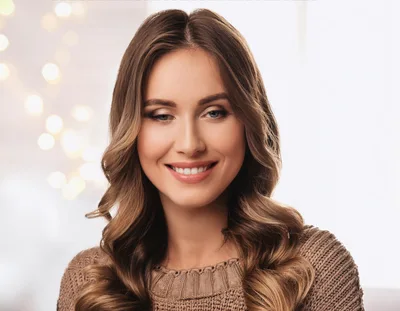 Portrait Of A Smiling Young Woman With Wavy Hair