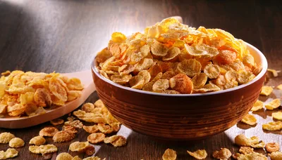 Bowl Of Crunchy Cornflakes On A Wooden Table