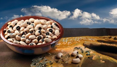 Bowl Of Dried Black Eyed Peas On Patterned Fabric