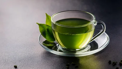 Glass Cup Of Green Tea With Fresh Leaves