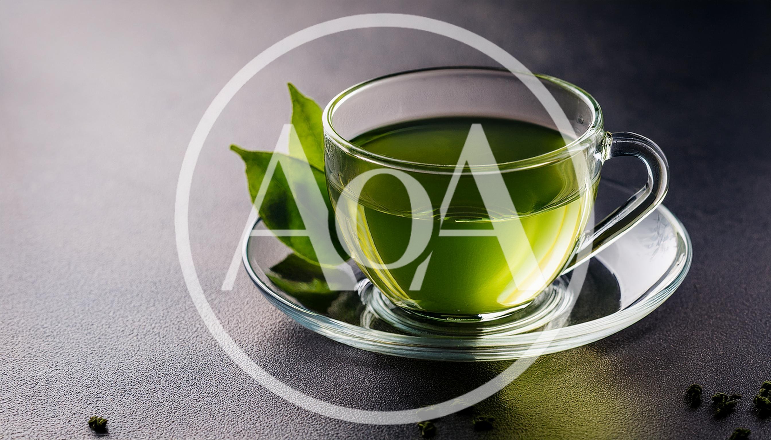 Glass Cup Of Green Tea With Fresh Leaves
