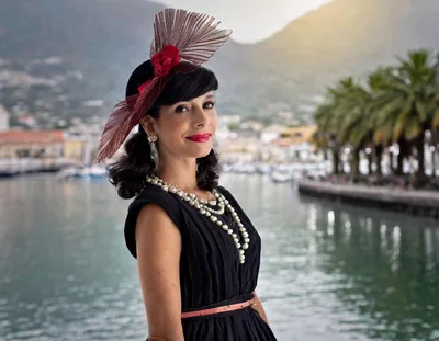 Elegant Woman Wearing Vintage Hat And Pearls By Harbor