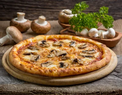Fresh Mushroom Pizza On A Wooden Serving Board